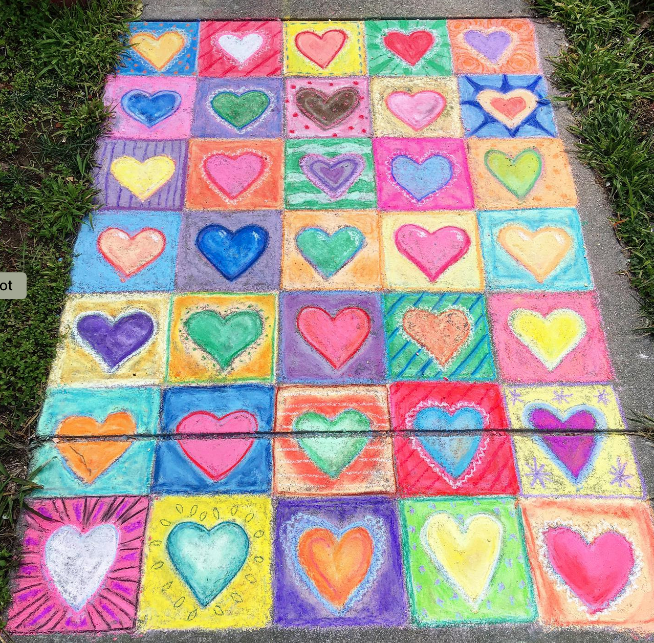 A colorful chalk mural on pavement, with 35 hearts in a 5x7 grid, like a quilt